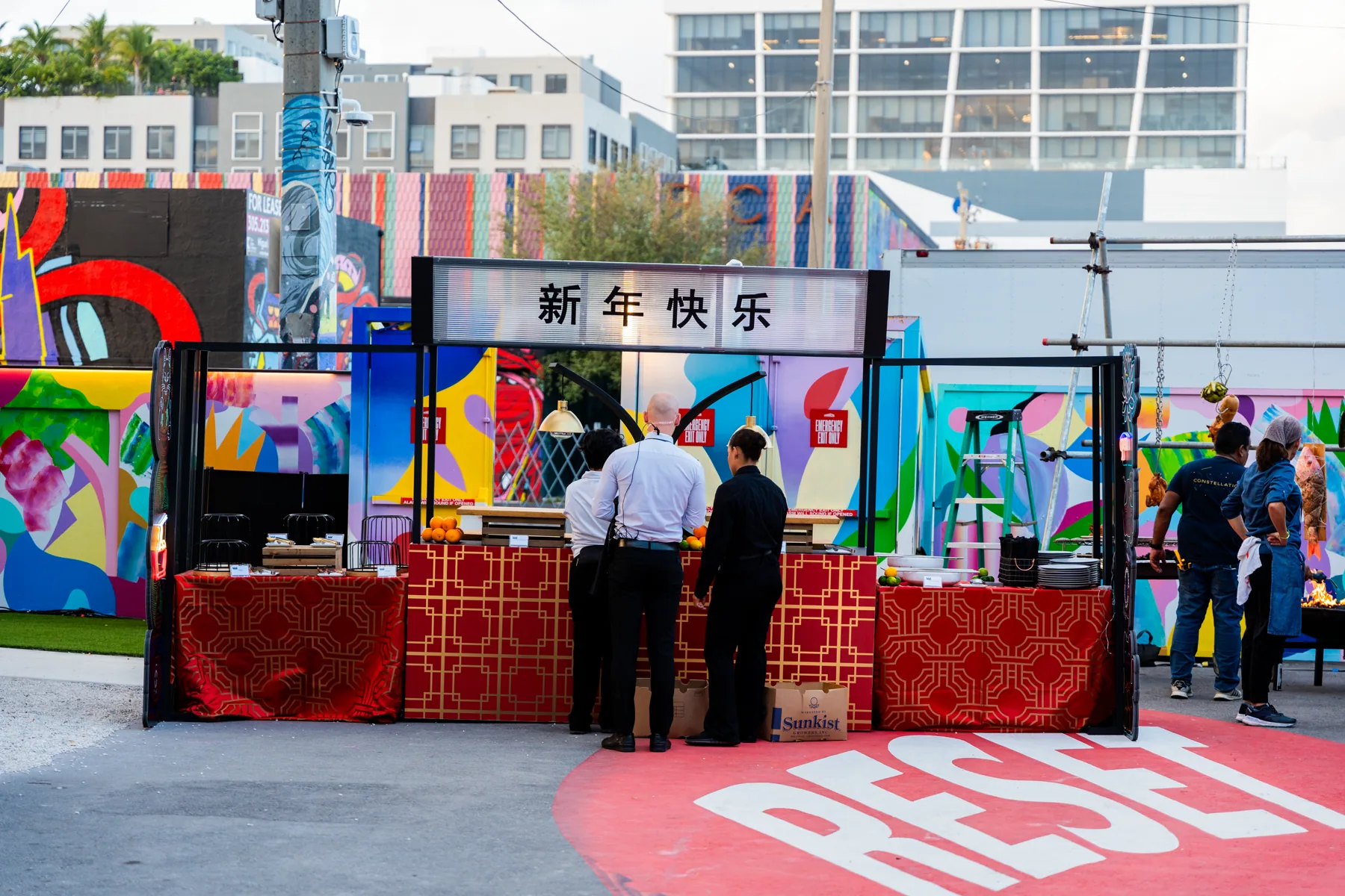 Guests exploring the Citadel Lunar New Year culinary stations at Wynwood Walls