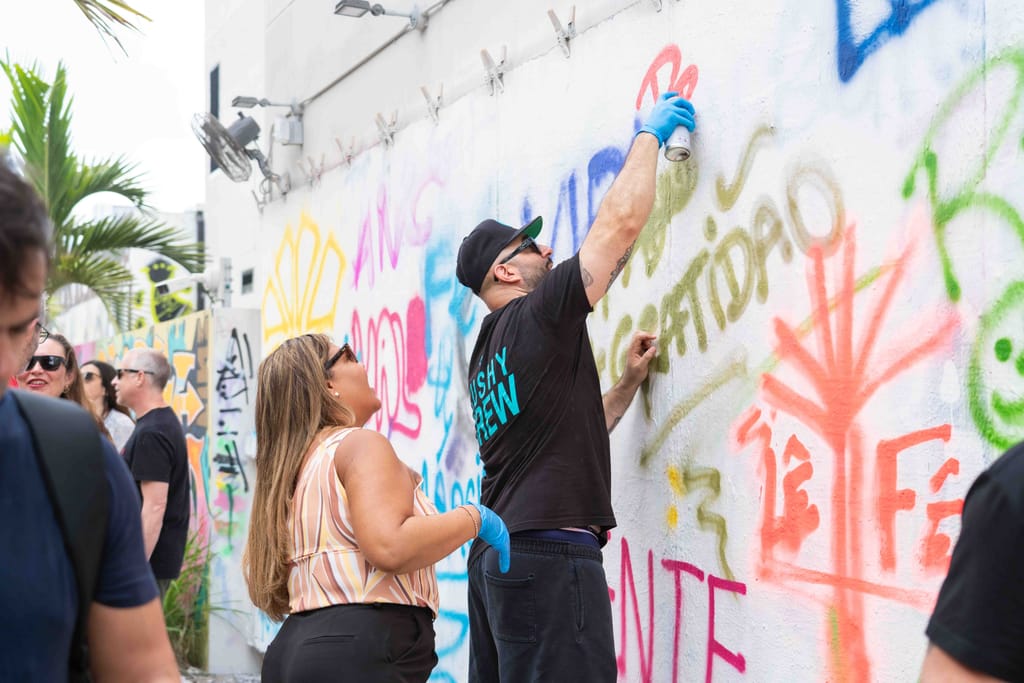Guests spray painting during an experience at Wynwood Walls