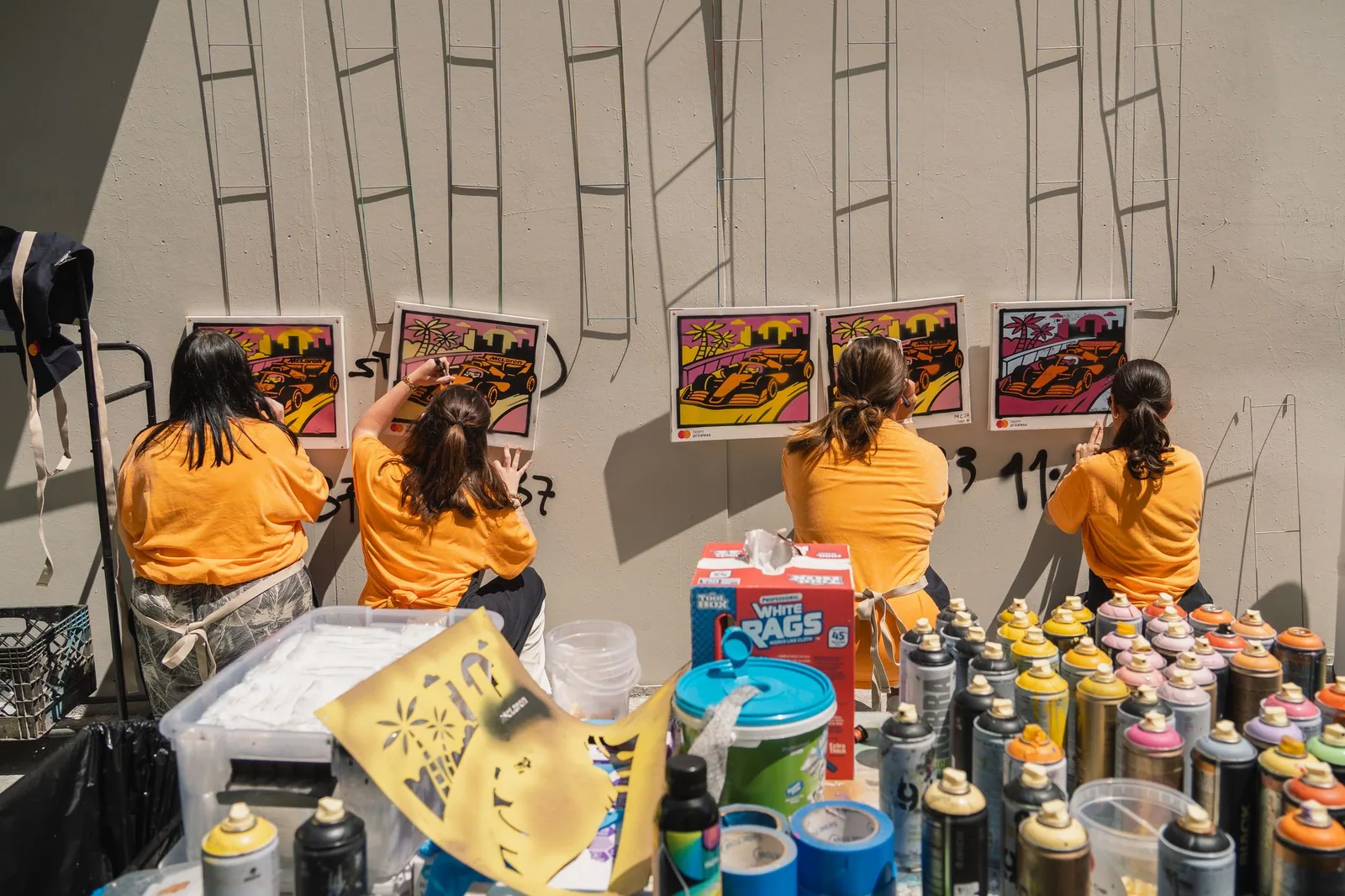 Team Priceless participants creating McLaren-inspired artwork together