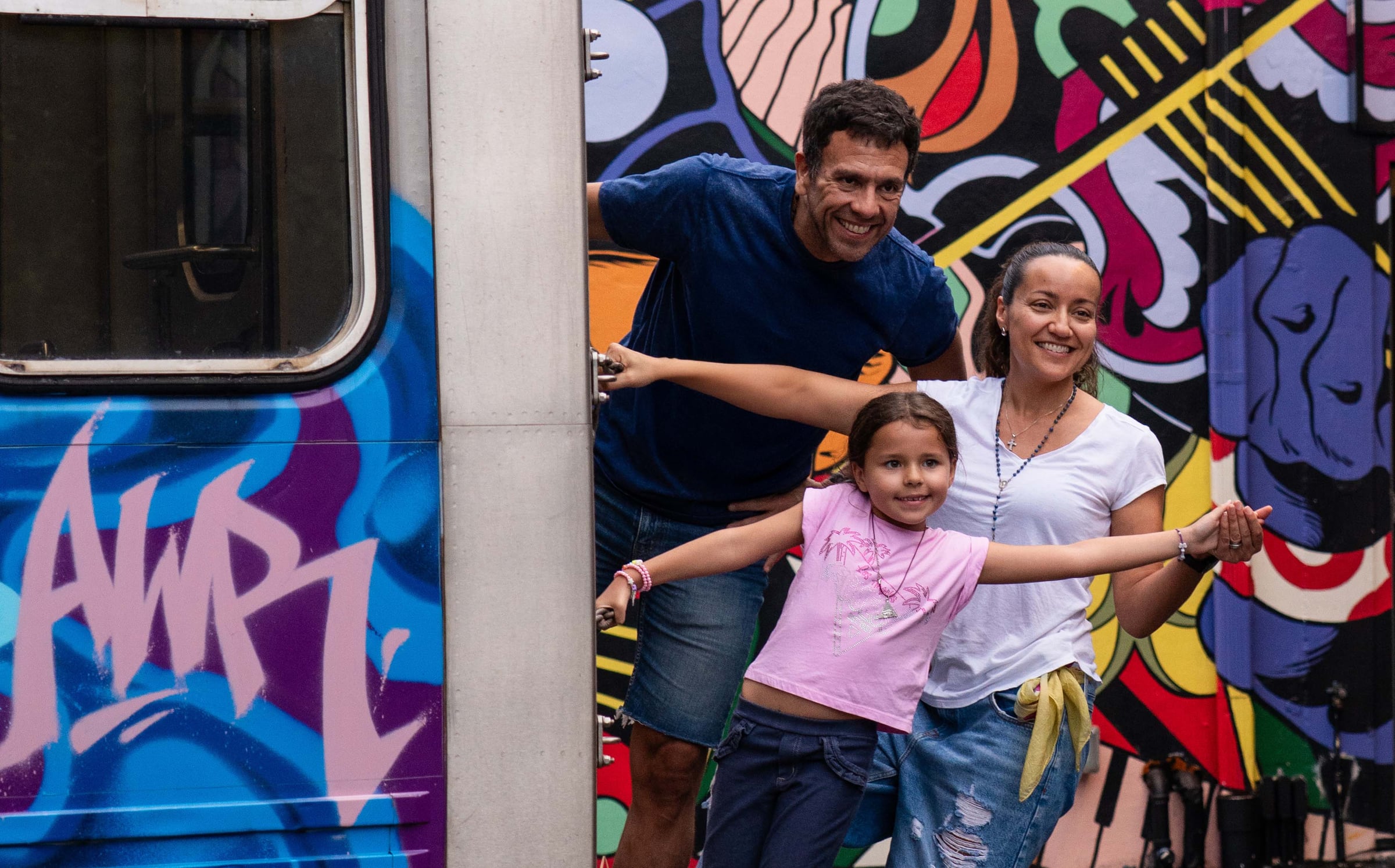 A family enjoying the painted subway installation at Wynwood Walls